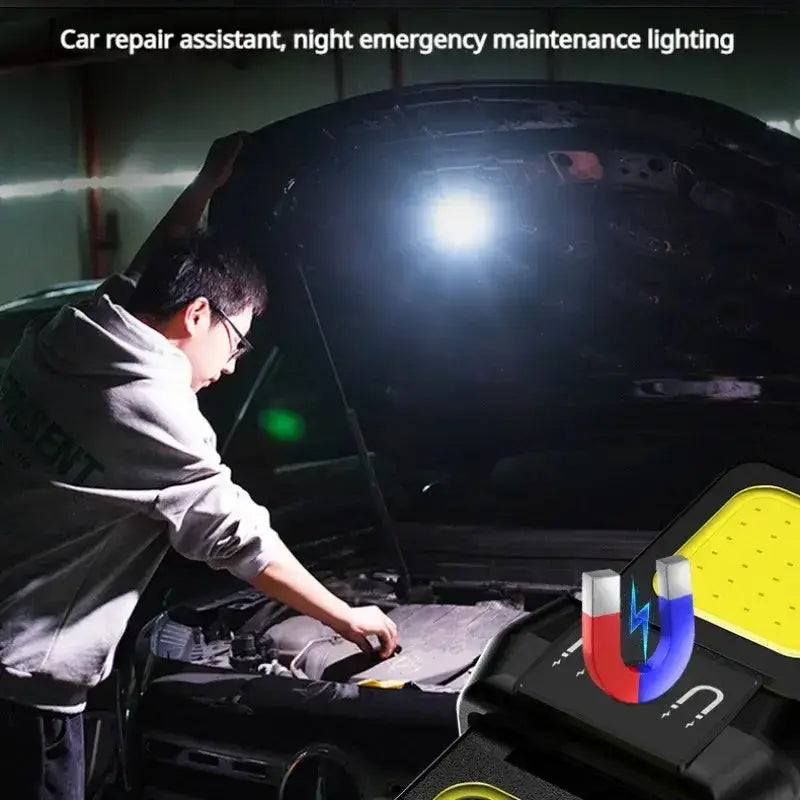 Person using LED flashlight for car repair in dark garage, highlighting emergency maintenance lighting feature.
