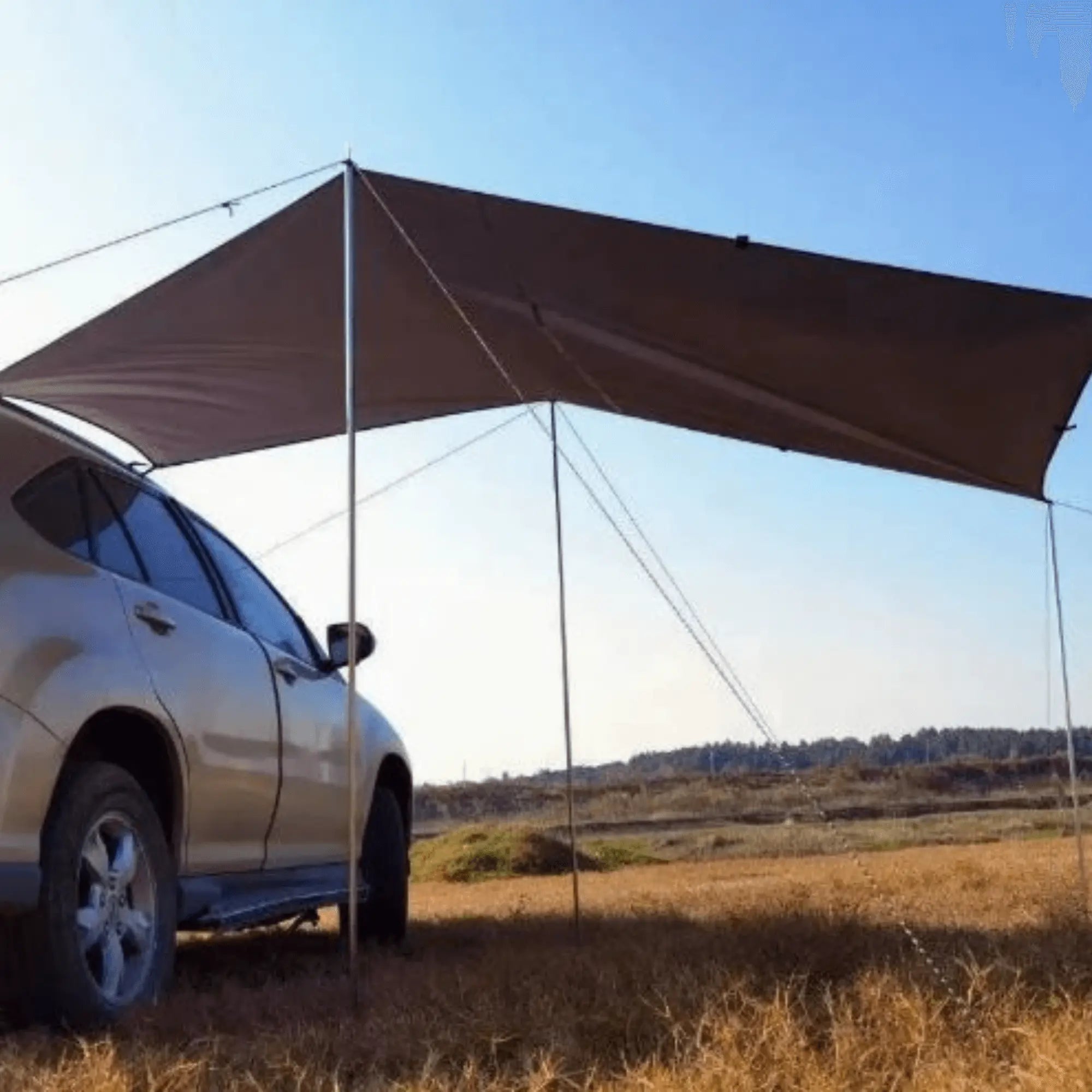 Adjustable tent poles supporting a car awning in a sunny outdoor setting, ideal for camping and road trips.