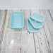 Lot de 5 boîtes à lunch rectangulaires pliables en silicone sur une table en bois.