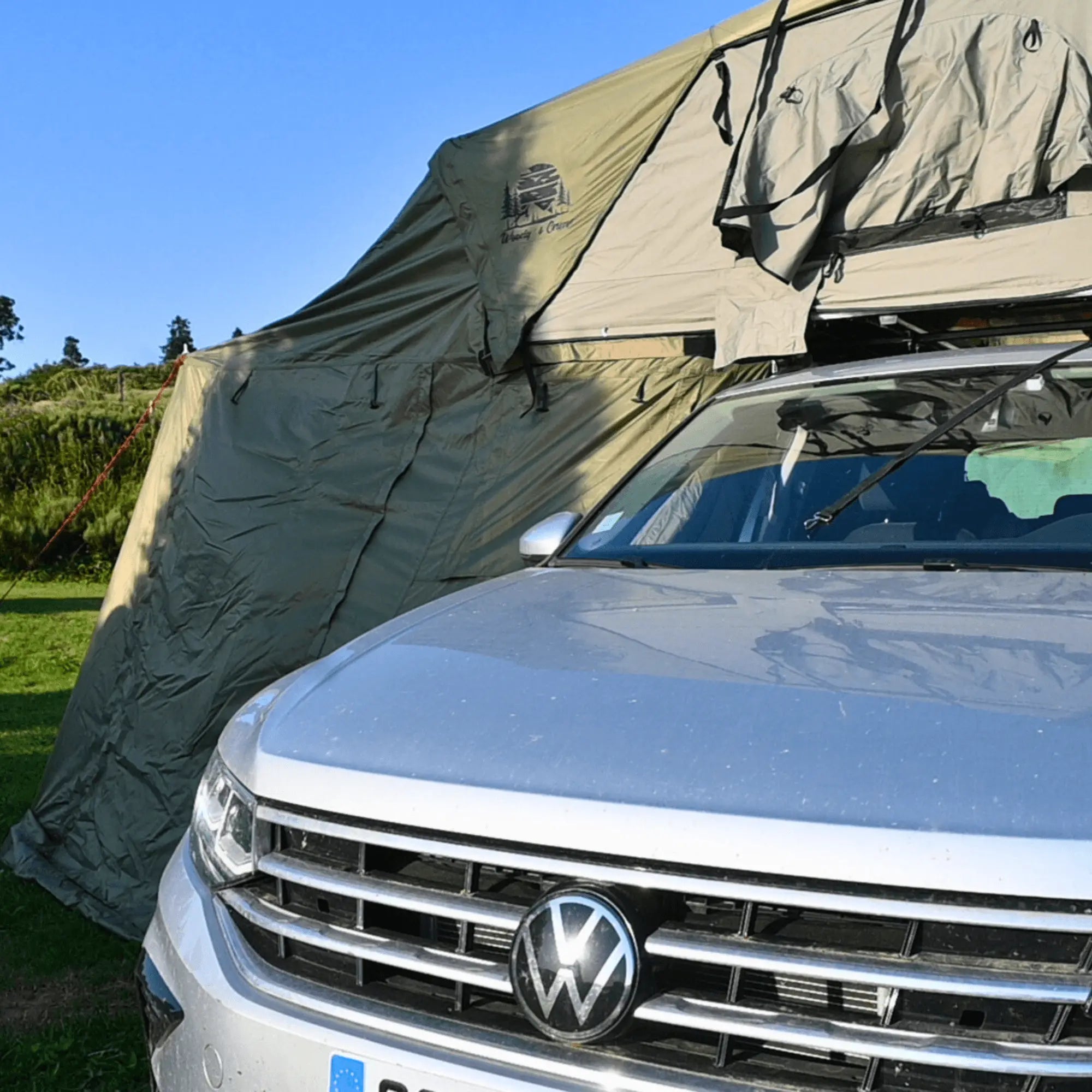 Roof tent annex attached to a car, providing extra living space for 2-3 people, ideal for outdoor camping adventures.