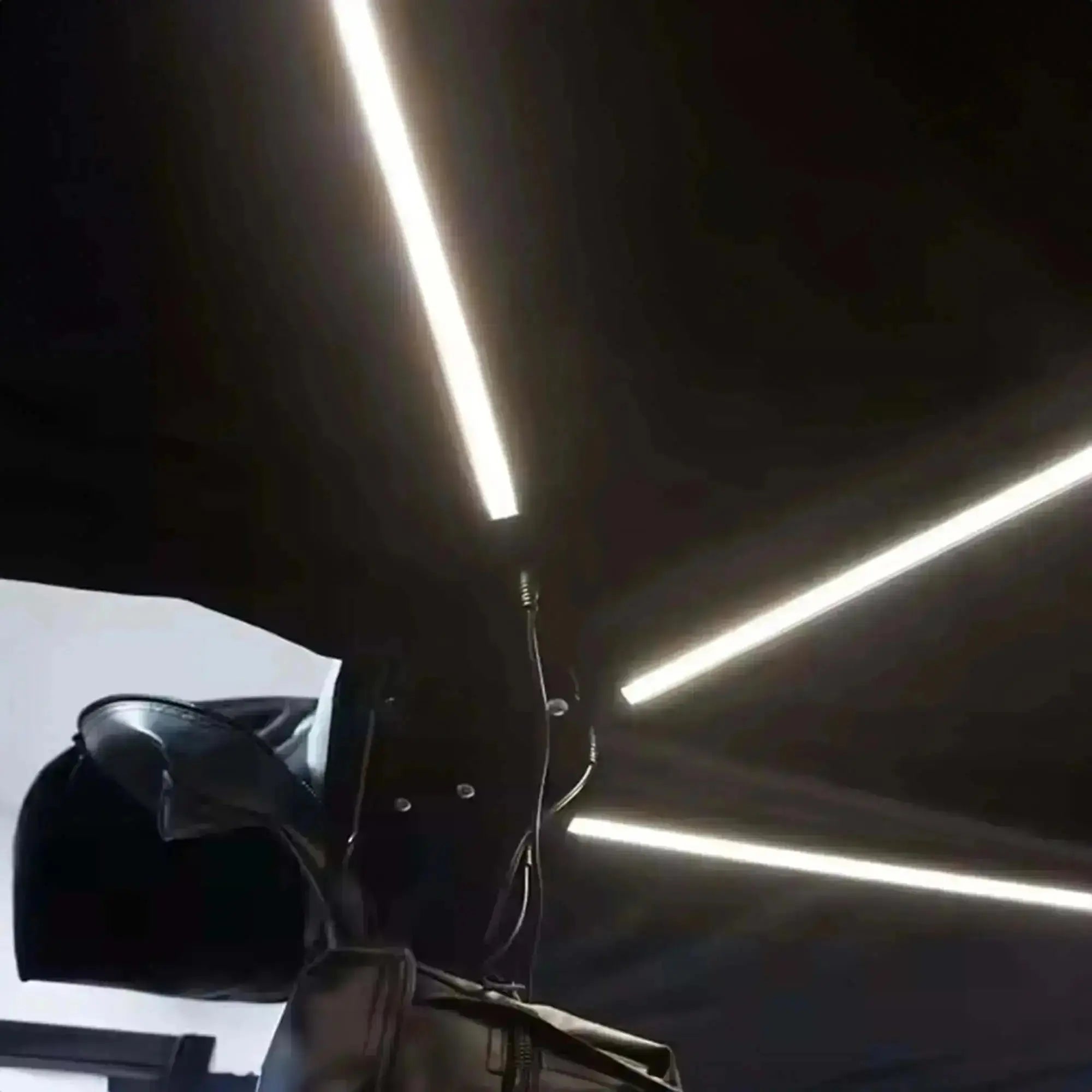 Close-up of 360° black self-supporting awning with integrated LED lights, featuring a sleek design for outdoor use.