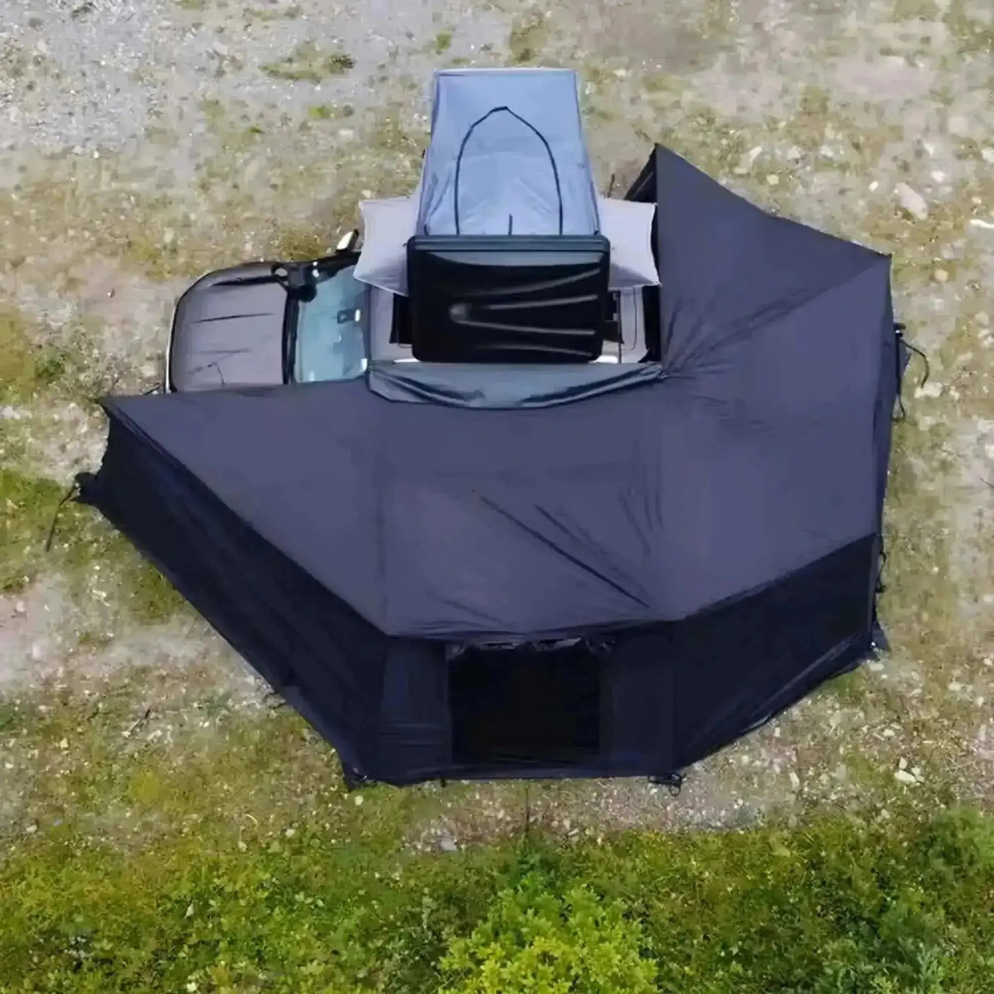 Overhead view of black freestanding 360° awning with integrated LEDs attached to vehicle, for 2025 pre-order.