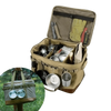 Boîte de transport pliable pour le camping avec armature métallique, remplie d'équipements divers et tasse accrochée, sur fond d'herbe.