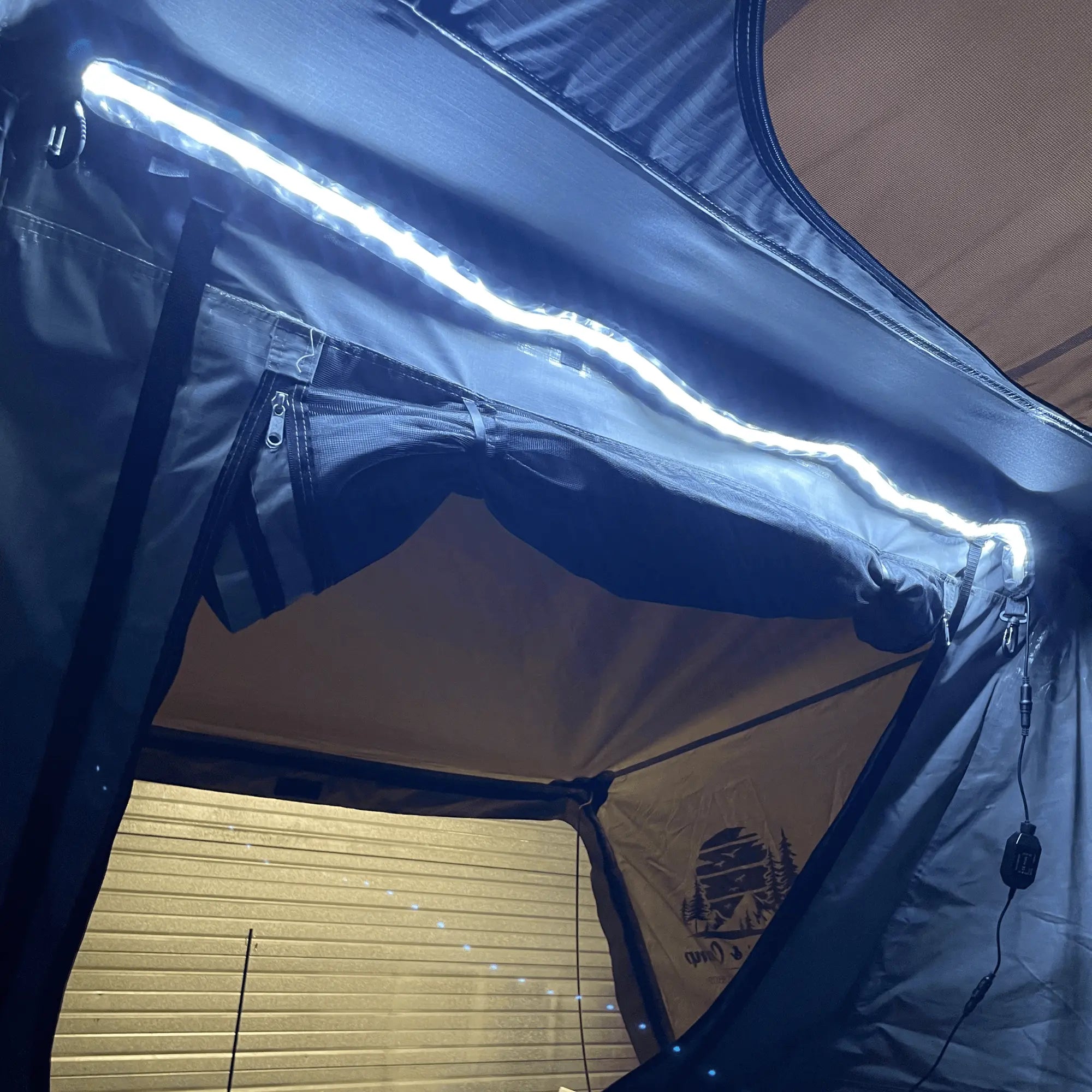 LED strip lighting inside a rooftop camping tent, providing bright, adjustable illumination, ideal for outdoor adventures.