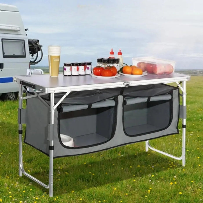 cuisine de camping pliante, meuble cuisine camping, table camping avec rangement, armoire camping pliable, cuisine outdoor portable, table de camping aluminium, meuble vanlife cuisine, équipement camping cuisine, table barbecue extérieure