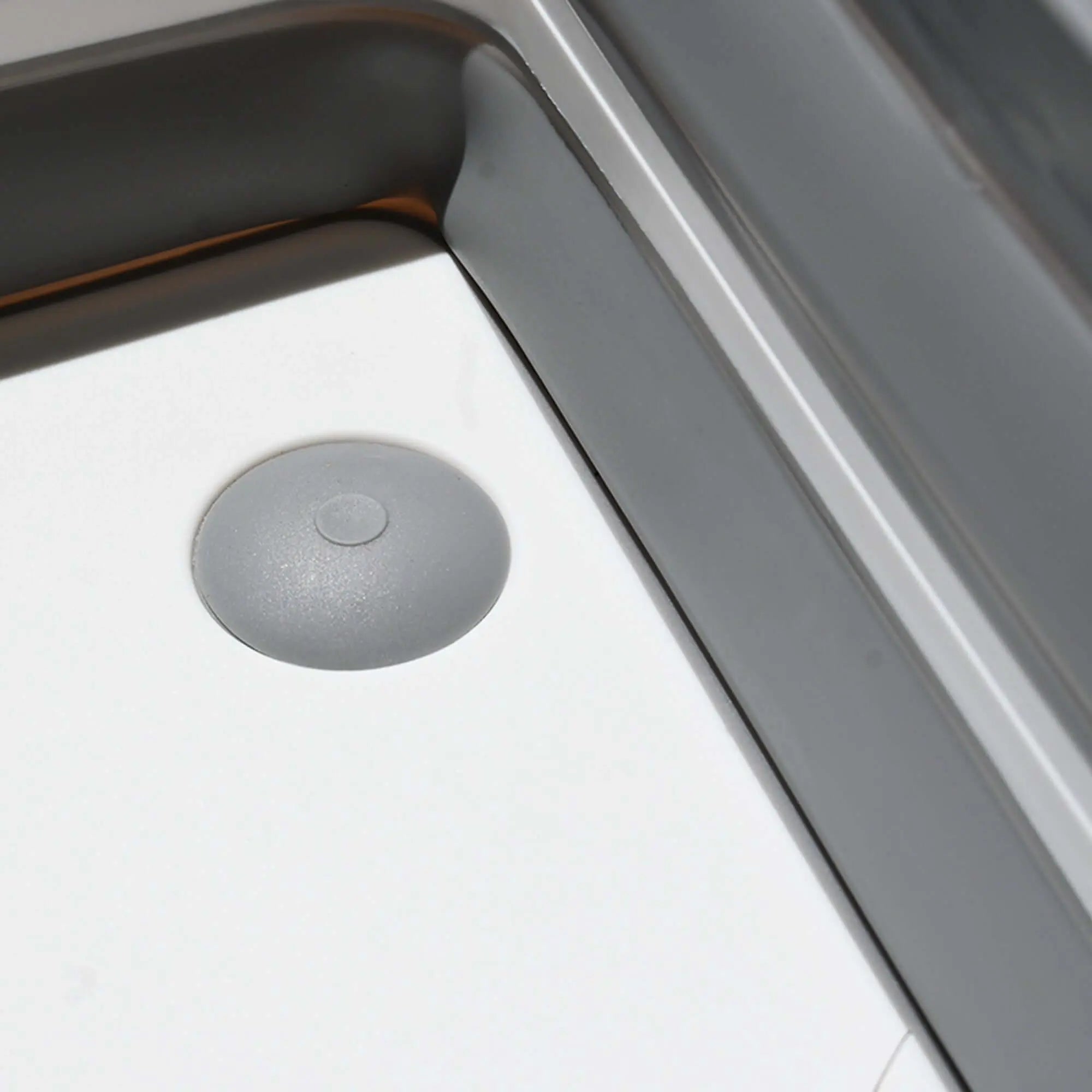 Close-up of a silicone foldable camping sink with a portable cutting board feature, ideal for outdoor cooking and van life.