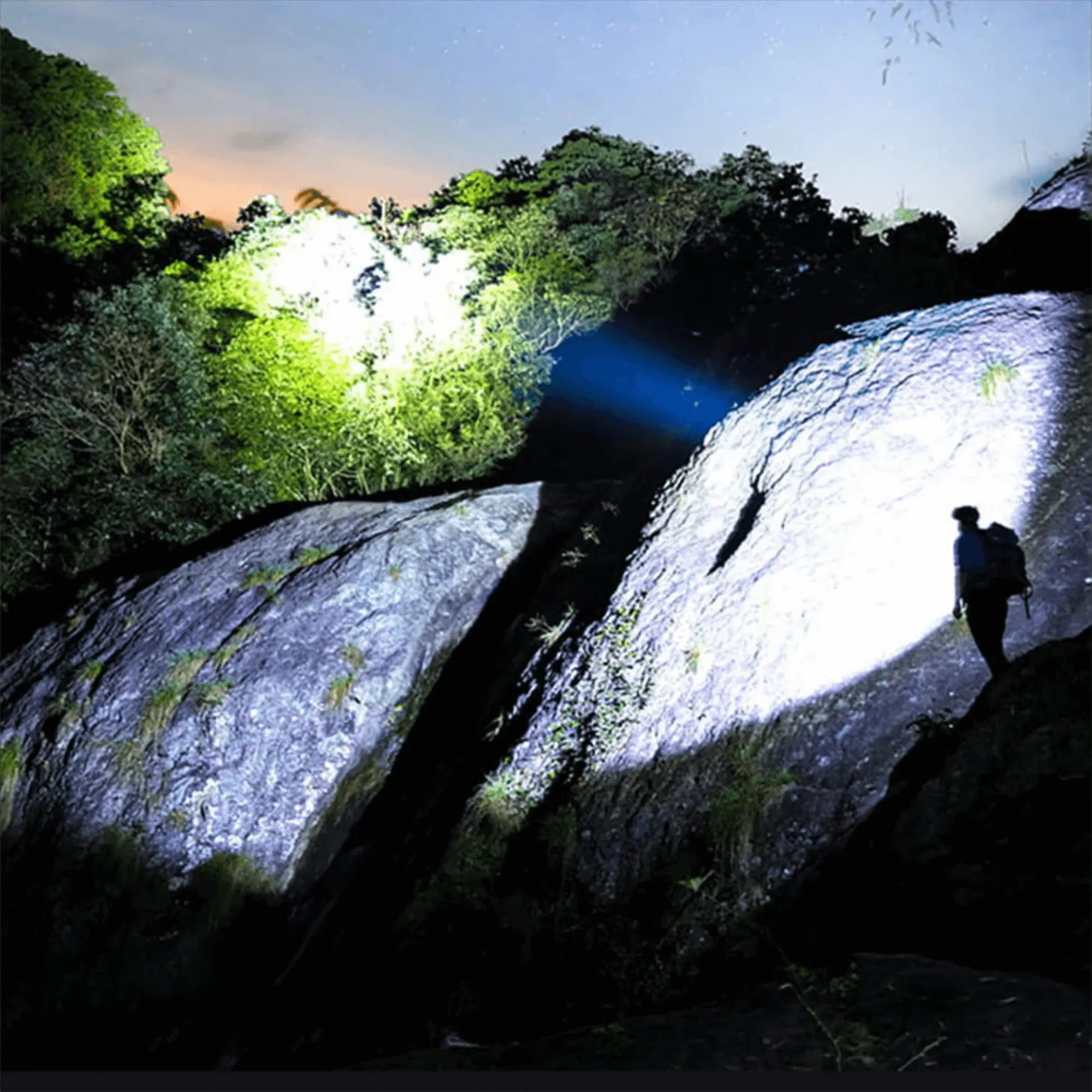Person using ultra-bright headlamp with 90,000 lumens for outdoor exploration on a rocky mountainside at night.