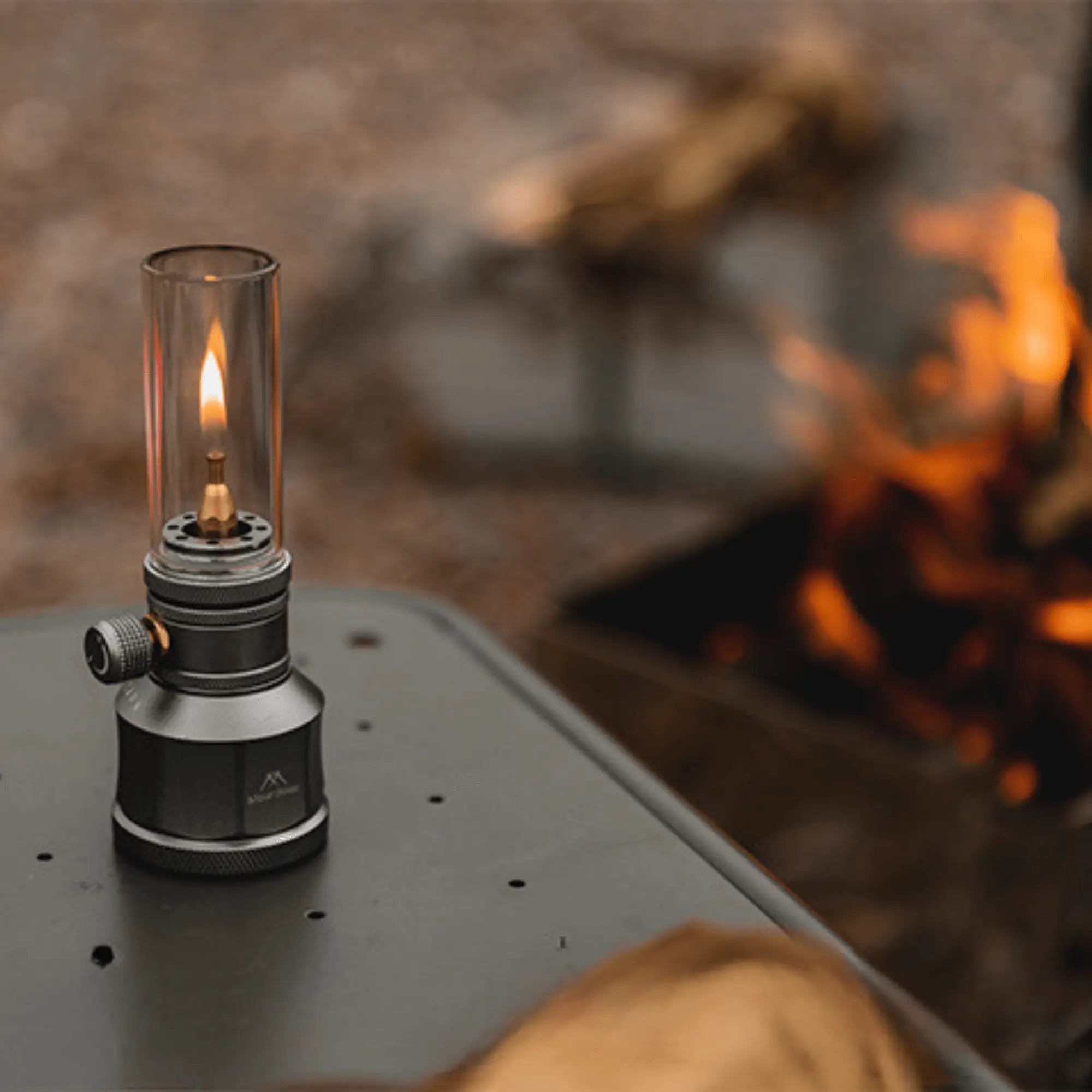 Rechargeable camping gas lantern on a table with warm glowing light, ideal for outdoor evenings and creating a cozy atmosphere.