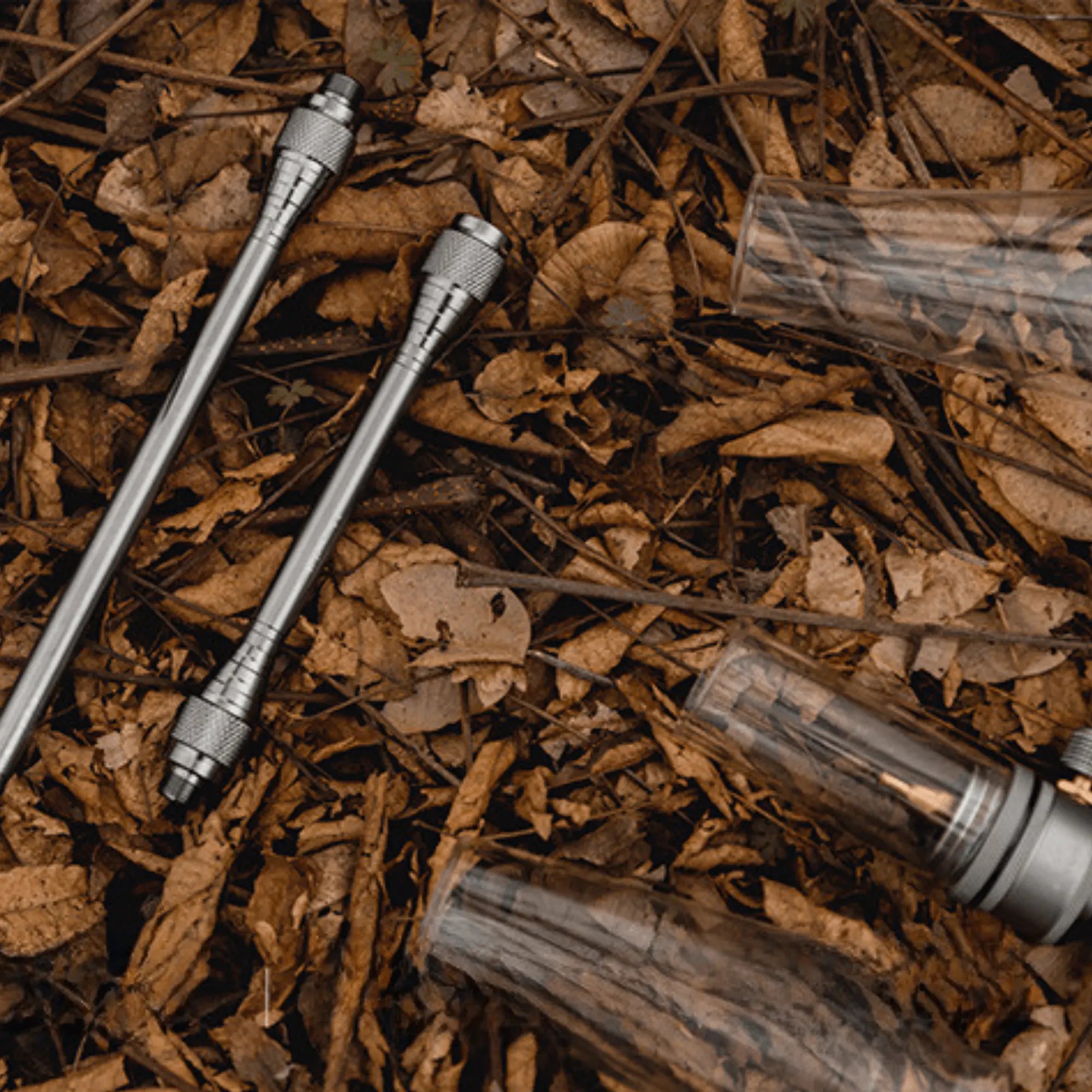 Camping gas lantern parts on forest ground, showcasing outdoor adventure equipment for customized lighting solutions.