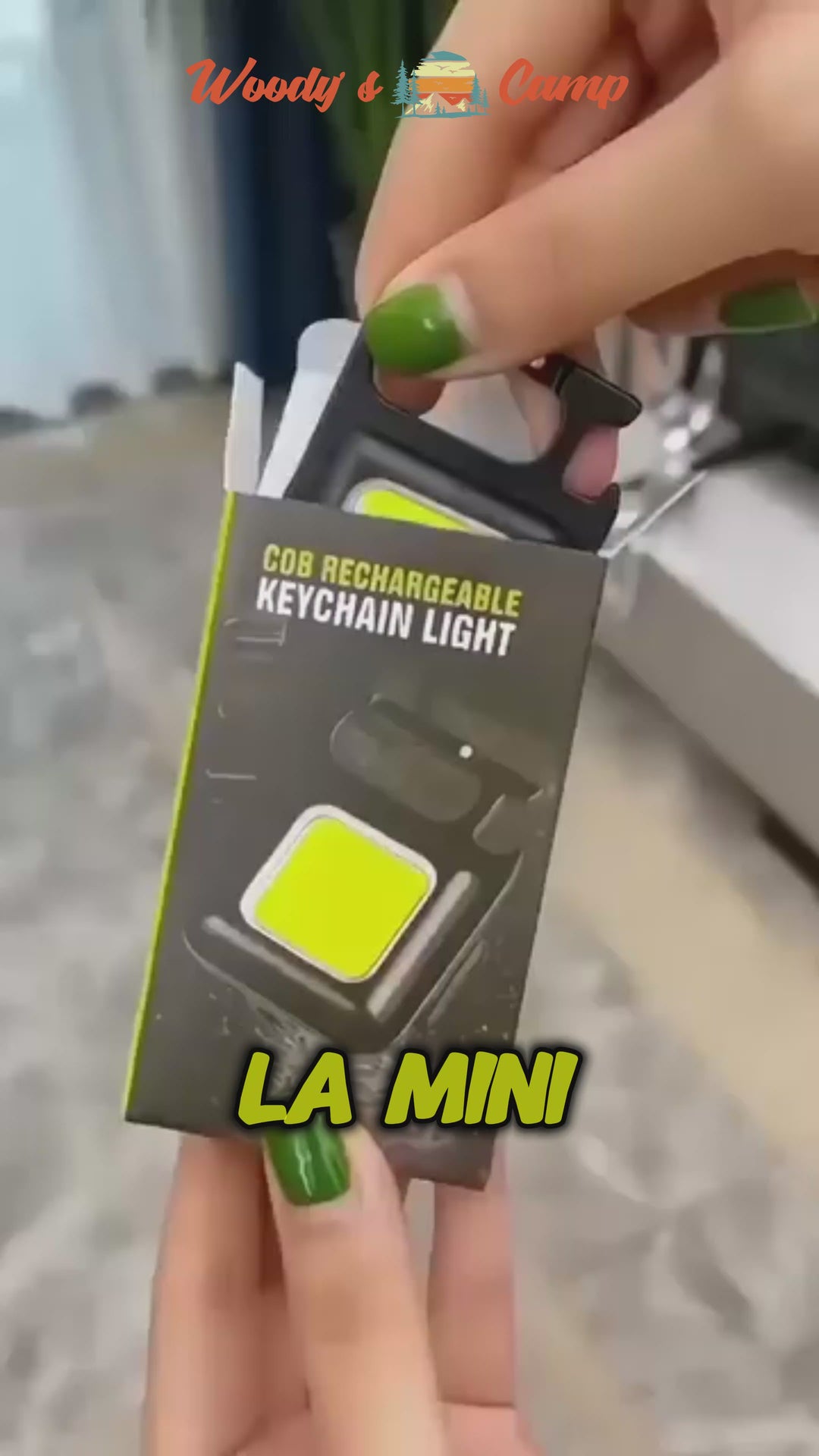 Person holding a compact rechargeable LED keychain light package labeled 'LA MINI' in hand.