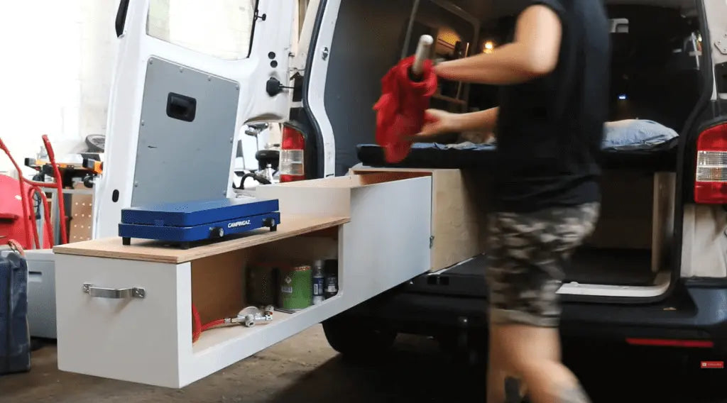 Van storage drawer with ball bearing slides extended, showcasing organized tools and equipment for efficient space use.