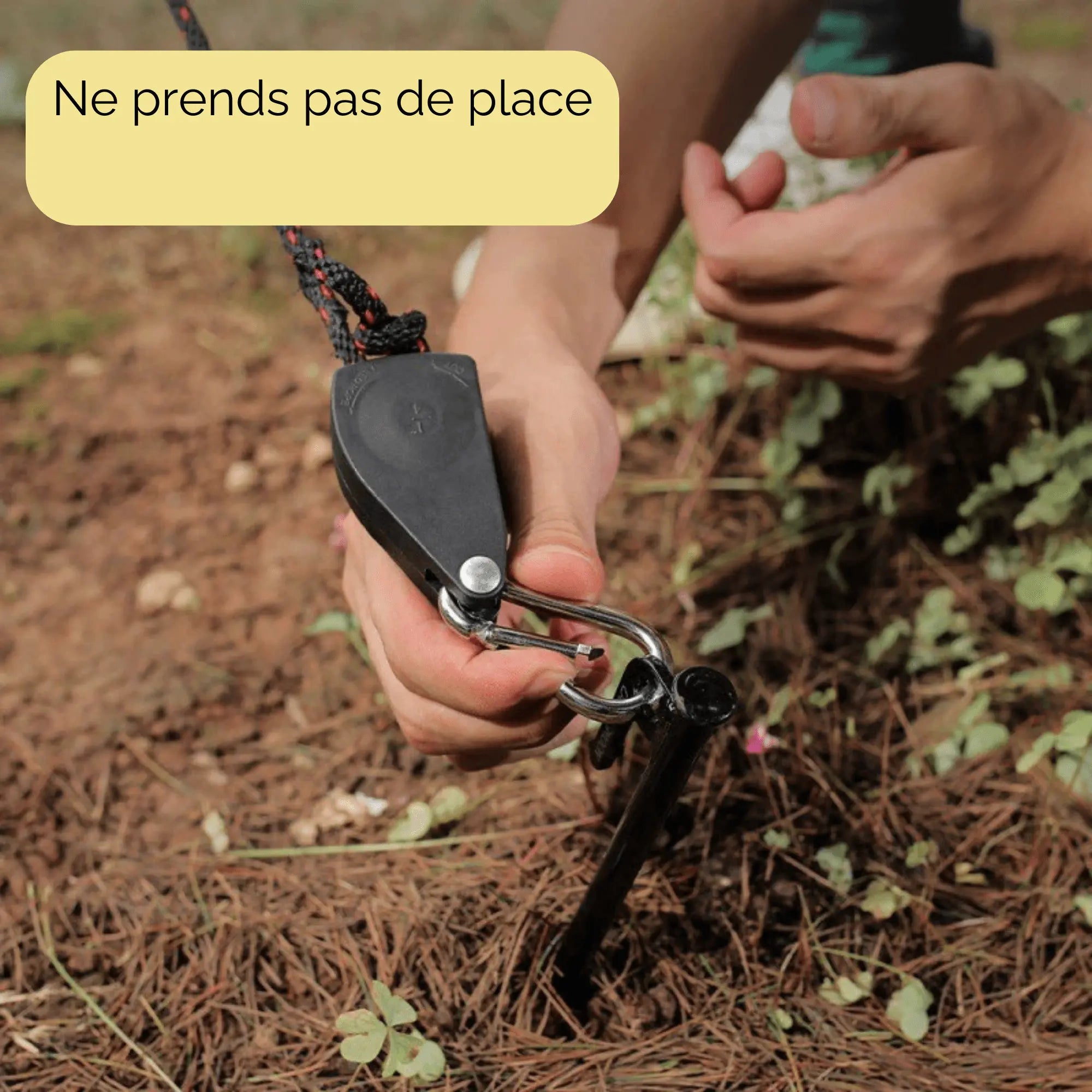 Using a windproof cord clamp with pulley on camping ground. Ensures stability for tents and outdoor gear. Compact and reliable camping tool.