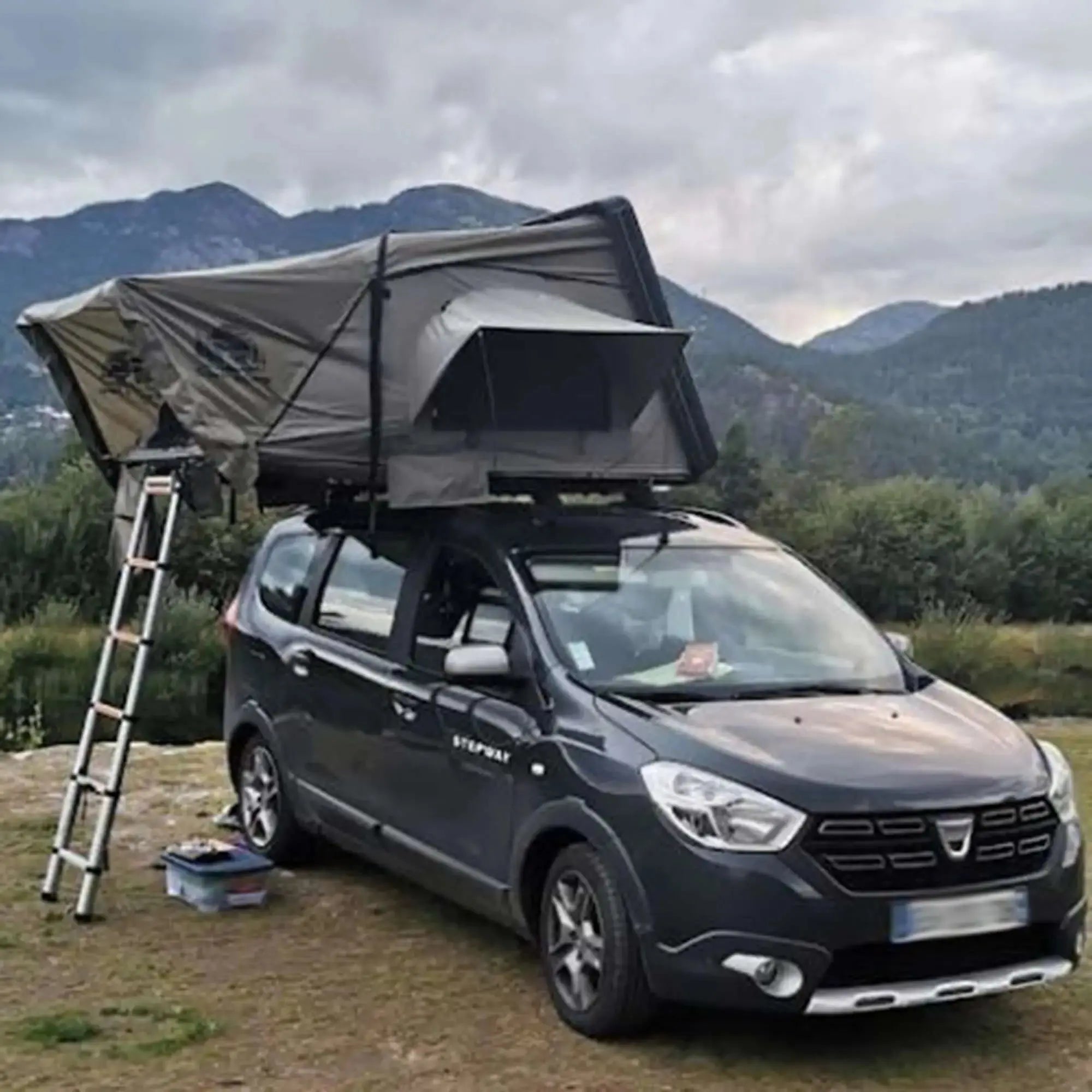 Car with rooftop tent and annex set up in a scenic outdoor location, ideal for family camping and adventure trips.