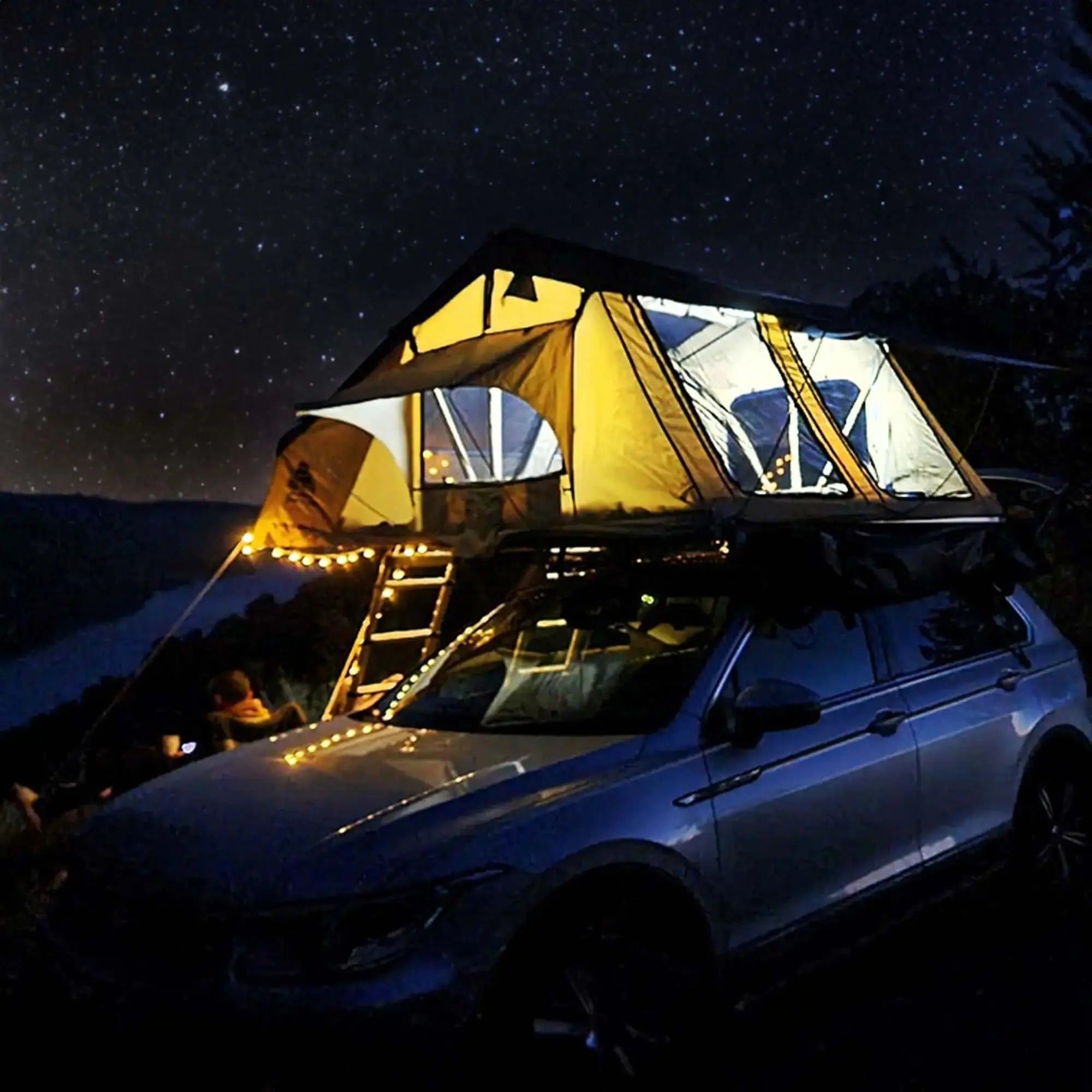 Roof tent set up at night on car with starry sky, ideal for 4-5 people. Preorder for 2025. Beige with black roof.