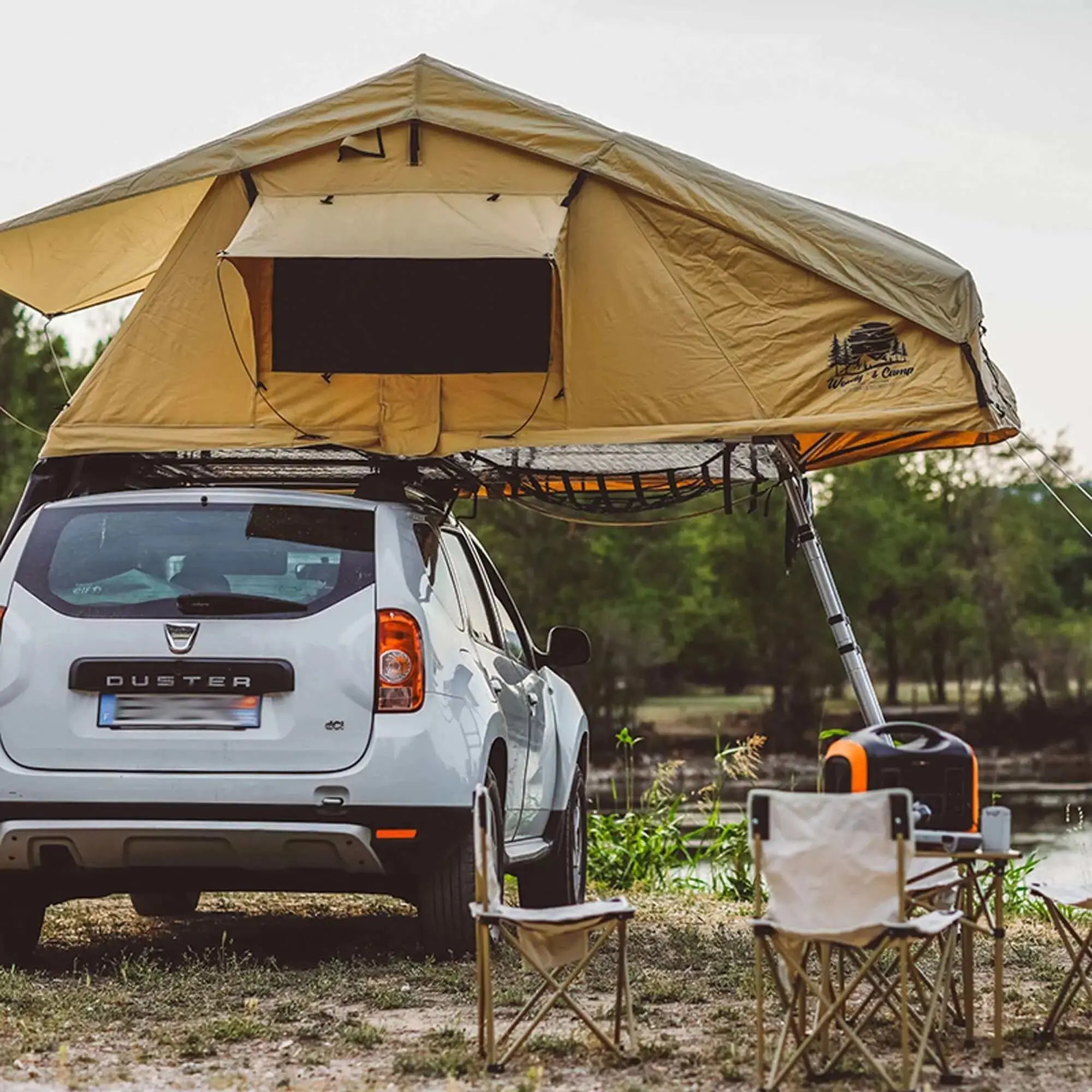 Car with rooftop tent for 2-3 people, set up for camping adventure in nature. Ideal for family road trips. 2024-25 design.