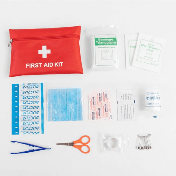 Trousse de premiers secours d'urgence avec 173 pièces pour le camping et les voyages, comprenant des bandages, des ciseaux, des pincettes et plus encore dans un étui rouge.