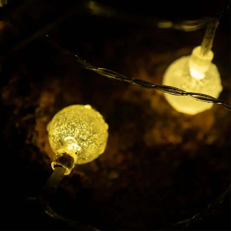 Close-up of LED solar/USB camping tent lights glowing warmly in the dark, ideal for outdoor adventures and sustainable illumination.