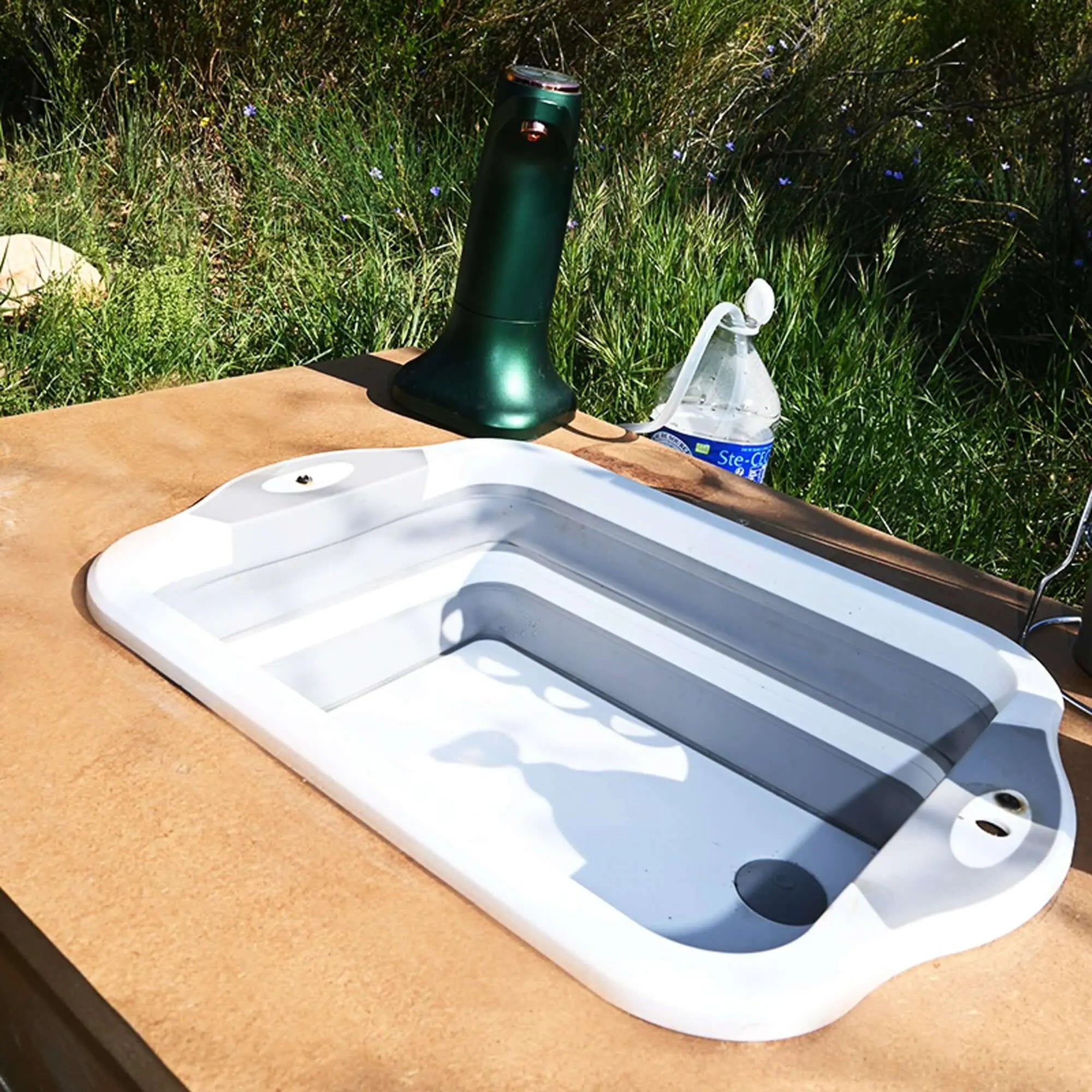 Compact foldable silicone camping sink on outdoor table