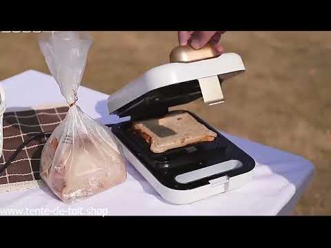 Portable sandwich maker toasting a sandwich outdoors.