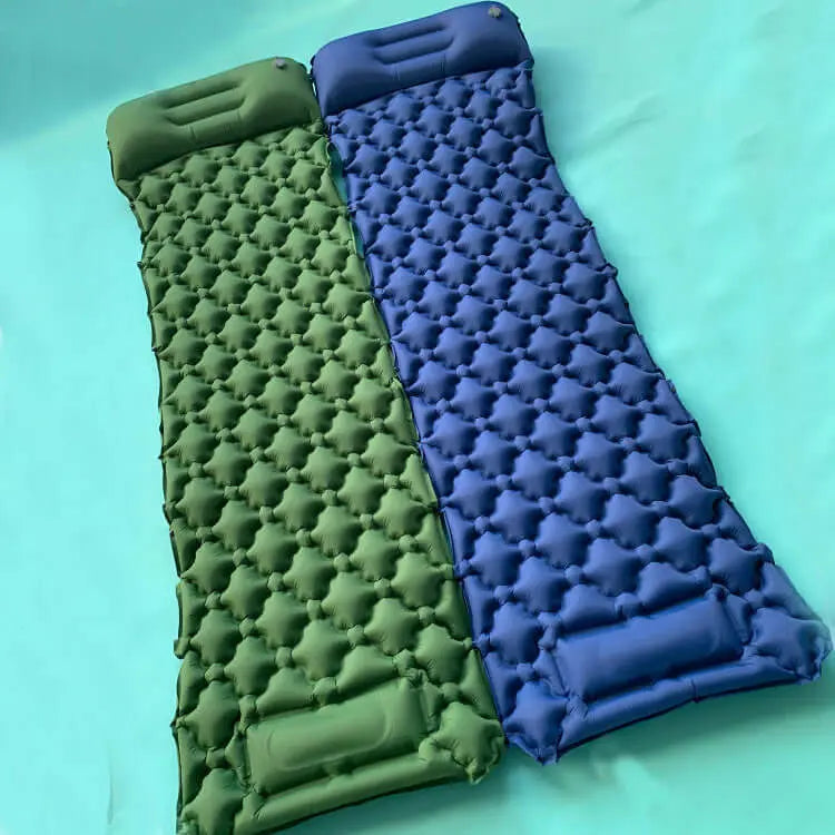 Green and blue inflatable air mattresses for rooftop tent camping. Offers comfort and space-saving design, suitable for outdoor adventures.