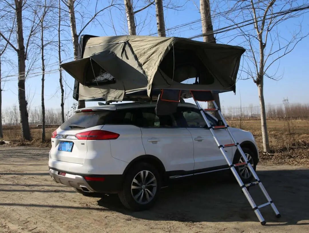 Car with rooftop tent set up for 4-5 people in a wooded area, showcasing camping accessibility.