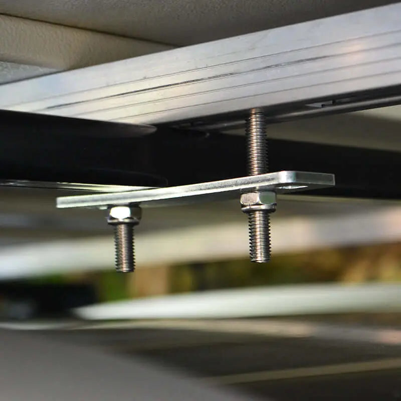 Close-up of mounting hardware for rooftop tent installation on vehicle.